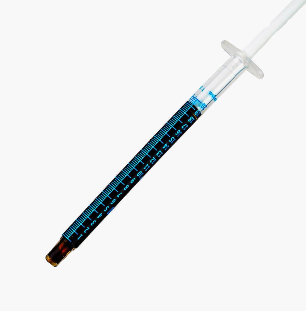 A Rick Simpson Oil syringe filled with thick dark coloured THC oil.