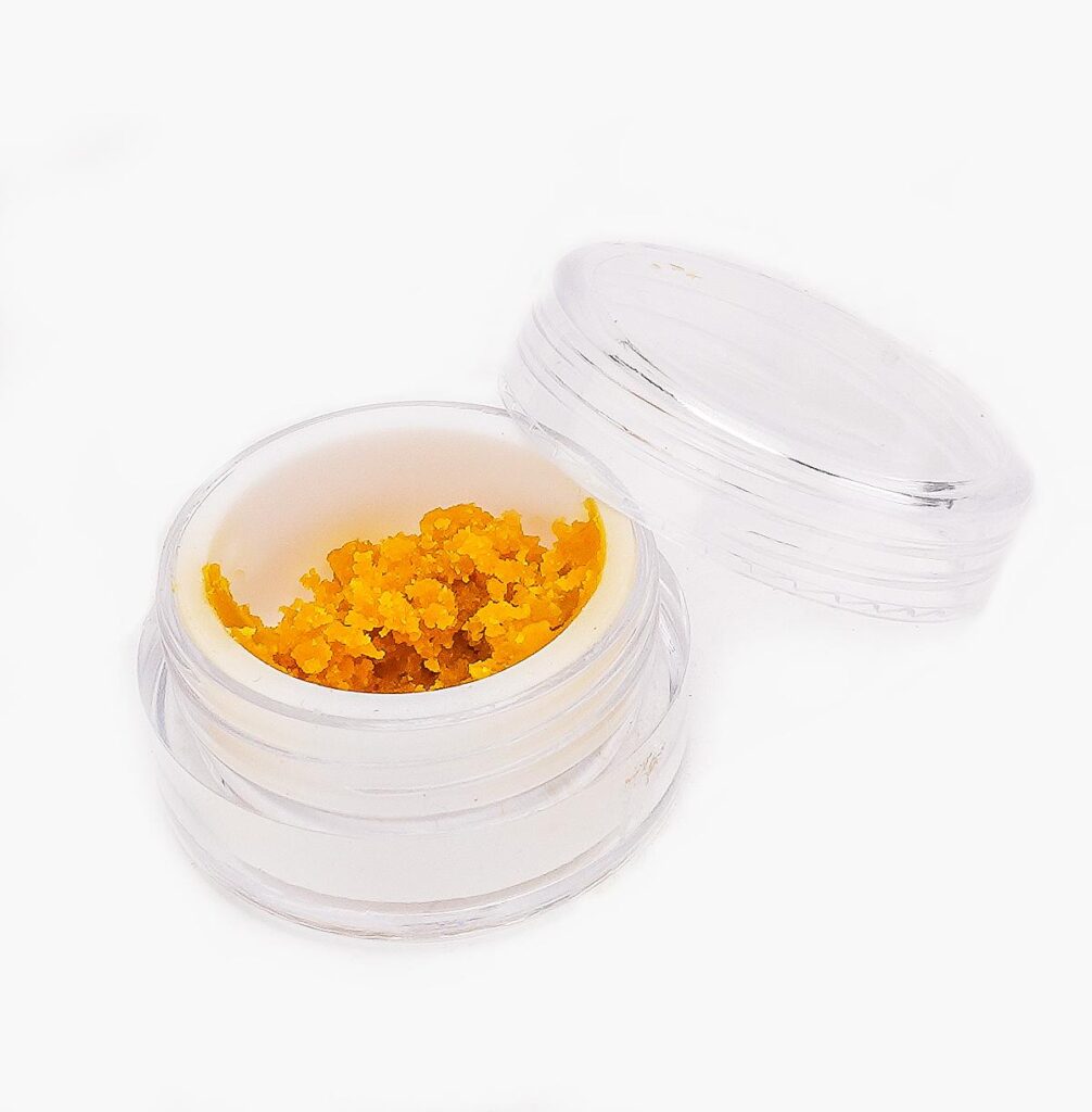 A small jar if Jager Budder from Seven Star; the contents are bright amber with crumbly texture.
