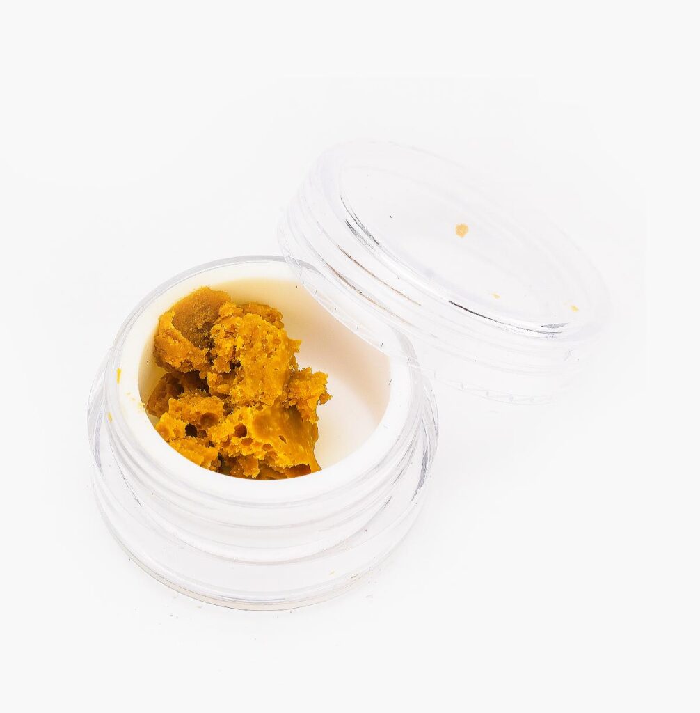 A small jar of Sour Diesel THC budder from Seven Star; it's deep amber in colour and crumbly in texture.