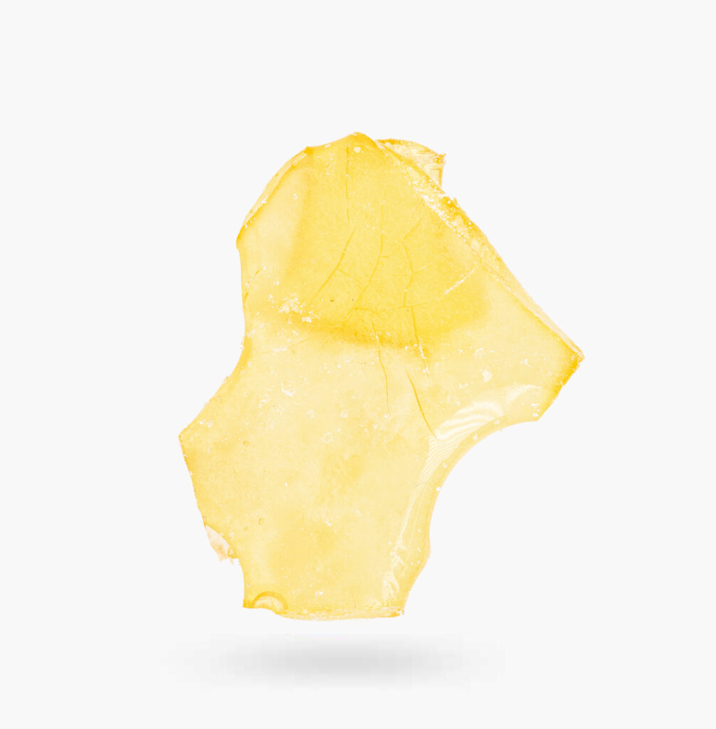 A piece of Burt Reynolds shatter produced by Dab Habit; it's semi-translucent and bright gold in colour.