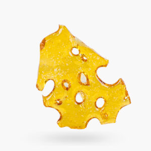 A piece of Extreme Cream Shatter produced by MQC; its semi-translucent, bright gold and has swiss cheese type holes.